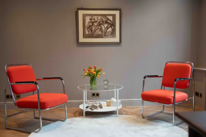 Therapieraum mit zwei Stühlen und Tisch für Gespräche